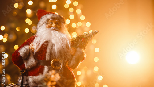 Santa Claus rotating against the Christmas tree  photo