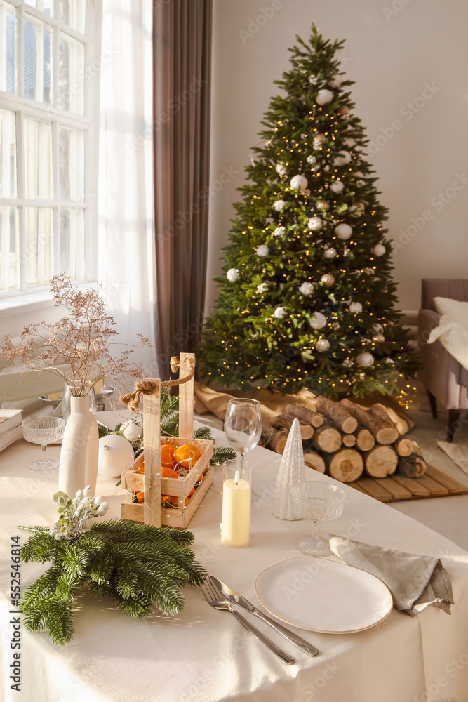 Beautiful table setting with Christmas decorations in living room. Dinner or lunch Beautiful table setting with Christmas decorations in living room. Dinner or lunch
