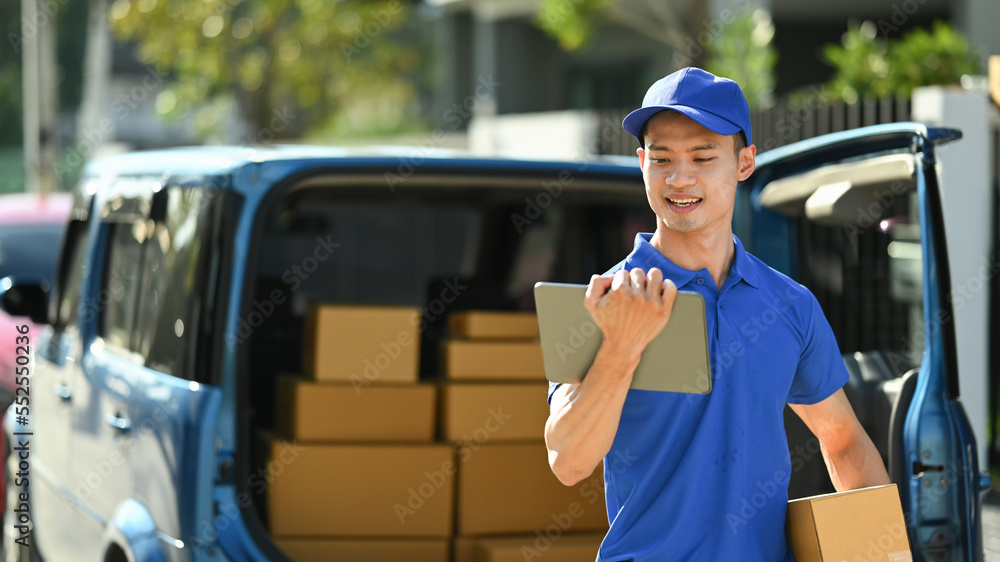Courier with parcel standing front of the delivery service van while making home delivery to his customer Courier with parcel standing front of the delivery service van while making home delivery to his customer