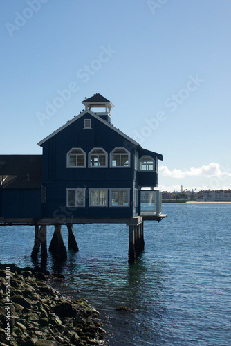 vintage waterfront building built on pylons in the harbor
