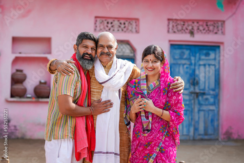 happy indian farmer with wife and father at home