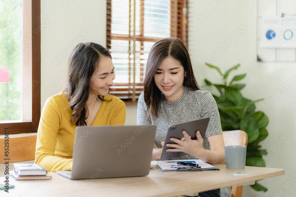 Two cute asian businesswoman sitting at table discussing financial accounting and investment project and planning strategy together at office. brainstorming ideas Two cute asian businesswoman sitting at table discussing financial accounting and investment project and planning strategy together at office. brainstorming ideas