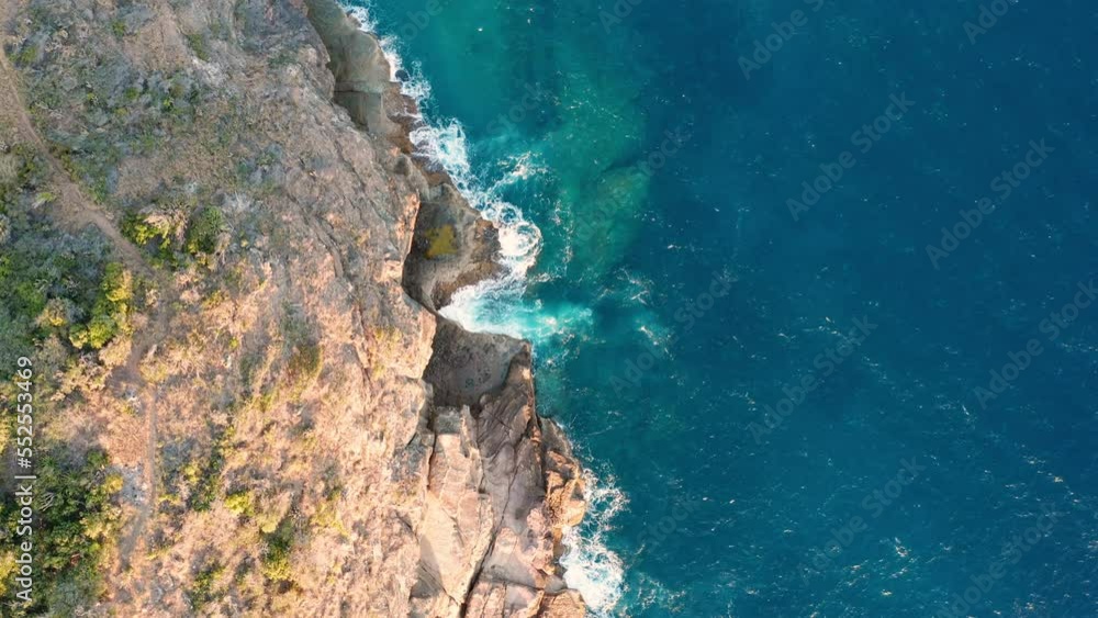 Aerial shot of ocean coast with views of waves and cliffs Aerial shot of ocean coast with views of waves and cliffs