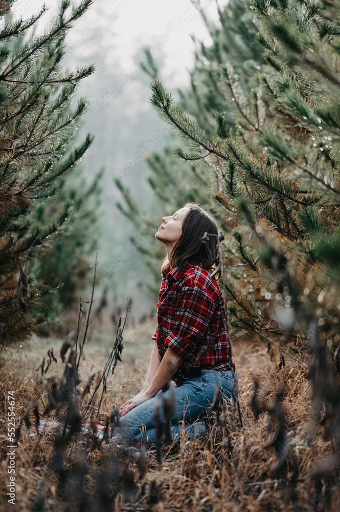 Naklejka premium Woman enjoy the pine wood forest - fashion photography
