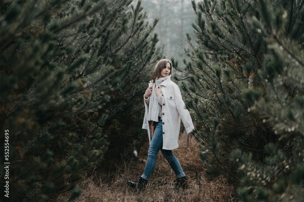 Naklejka premium Woman enjoy the pine wood forest - fashion photography