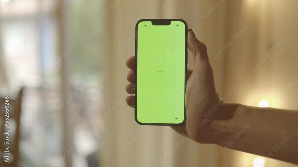 Close Up Hand Holding Iphone 13 Pro With Chroma Key Background Against