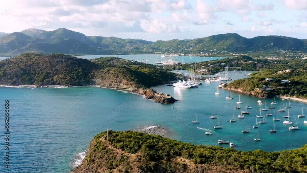 Sunny aerial shot of English Harbor in Antigua, Caribbean with views of yachts, sailboats, marina, bay and cliffs. Sunny aerial shot of English Harbor in Antigua, Caribbean with views of yachts, sailboats, marina, bay and cliffs.