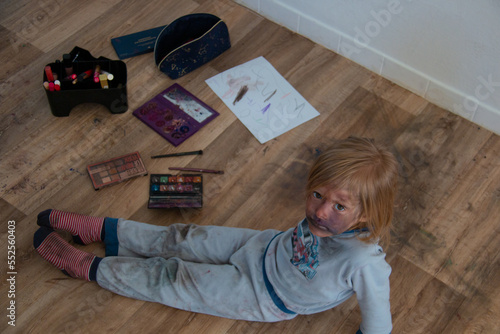 Fotografie Unsupervised child making mess with mother's make up, kid messed cosmetics all a