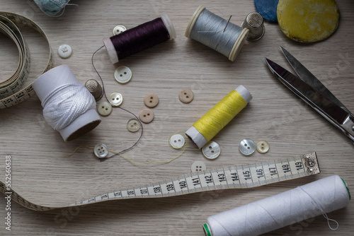 some of the tools needed to sew on a table