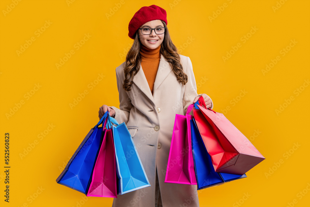 photo of happy stylish teen girl with shopping bags. teen girl hold shopping bags