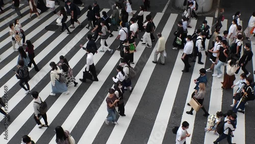 Wallpaper Mural OSAKA, JAPAN : Aerial high angle view of crowd of people walking at zebra crossing near Osaka station in daytime. Commuters at busy rush hour. Japanese lifestyle and business concept. Time lapse shot. Torontodigital.ca