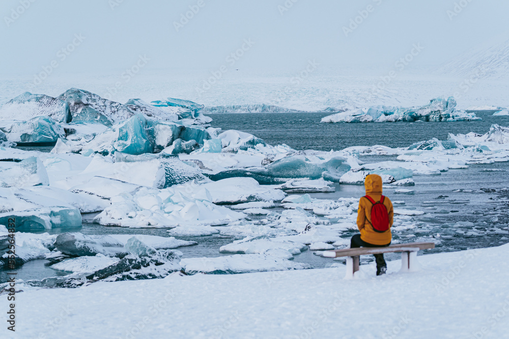 sitting woman watching the impressive glacier