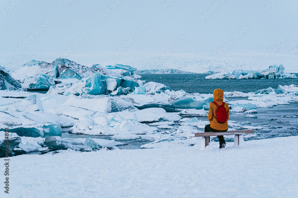 sitting woman watching the impressive glacier