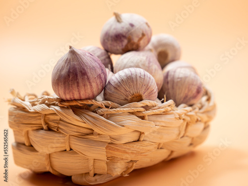 Heads of garlic on an orange background.