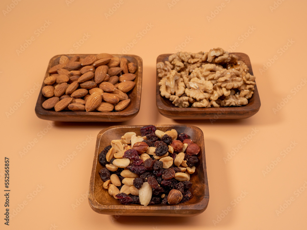 Various nuts on an orange background. Mixed nuts. Various nuts on an orange background. Mixed nuts.
