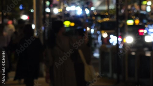 OSAKA, JAPAN -SEP 2022 : Back shot of crowd of people walking at business district near Osaka station at night. Busy street traffic background. Japanese city lifestyle concept video. Time lapse shot. photo