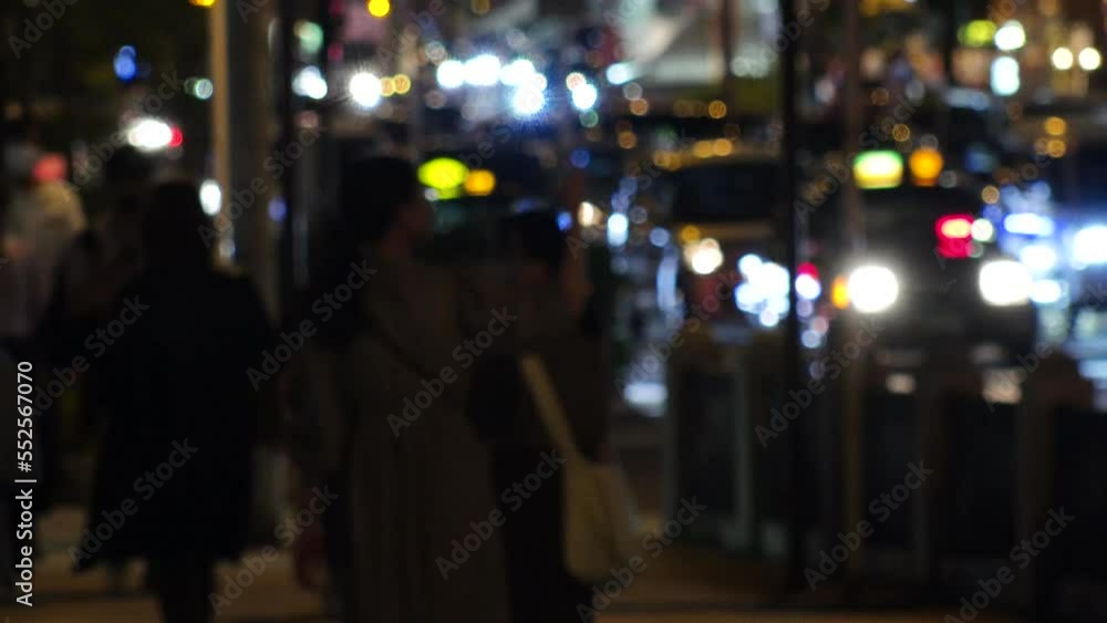 OSAKA, JAPAN -SEP 2022 : Back shot of crowd of people walking at business district near Osaka station at night. Busy street traffic background. Japanese city lifestyle concept video. Time lapse shot. OSAKA, JAPAN -SEP 2022 : Back shot of crowd of people walking at business district near Osaka station at night. Busy street traffic background. Japanese city lifestyle concept video. Time lapse shot.