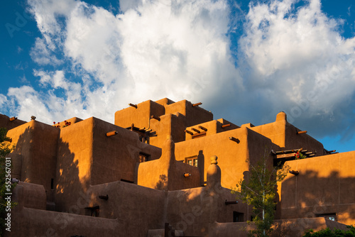 Dramatic white storm clouds over a pueblo style adobe building in Santa Fe, New Mexico photo