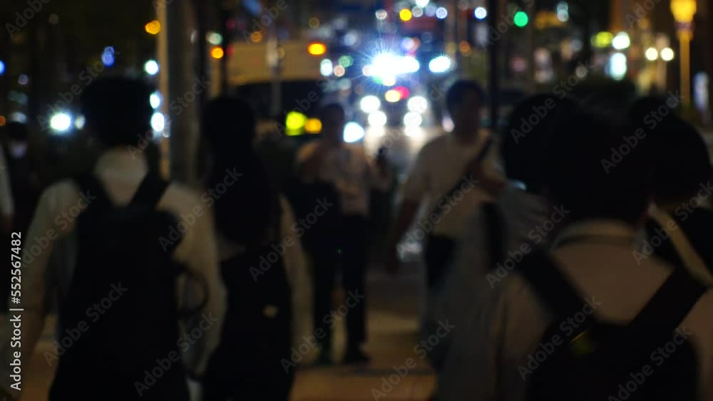 OSAKA, JAPAN -SEP 2022 : Back shot of crowd of people walking at business district near Osaka station at night. Busy street traffic background. Japanese city lifestyle and transportation concept video OSAKA, JAPAN -SEP 2022 : Back shot of crowd of people walking at business district near Osaka station at night. Busy street traffic background. Japanese city lifestyle and transportation concept video