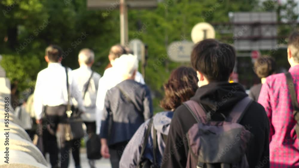 OSAKA, JAPAN - SEPTEMBER 2022 : Back shot of crowd of people walking around Yodoyabashi business district. Japanese lifestyle concept video. OSAKA, JAPAN - SEPTEMBER 2022 : Back shot of crowd of people walking around Yodoyabashi business district. Japanese lifestyle concept video.