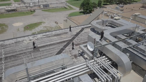 Static aerial shot of armed guards positioned on a rooftop photo