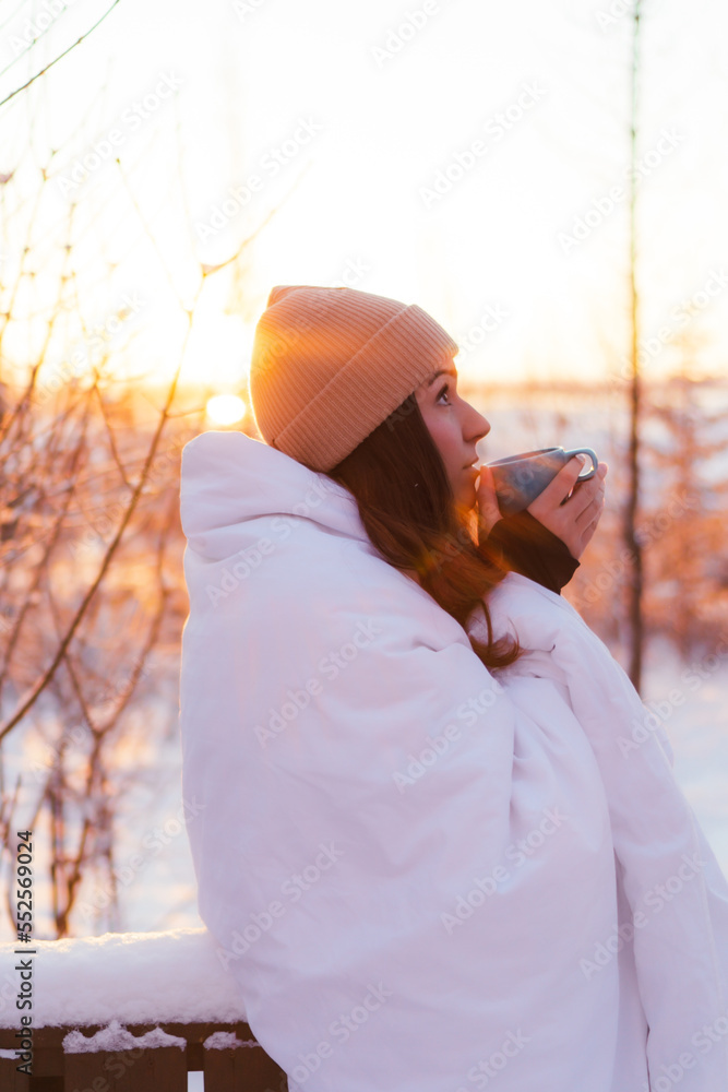 woman having breakfast on the terrace when everything is snowed in.