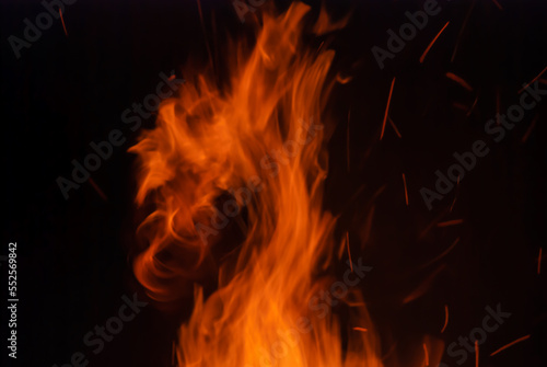 Abstract blaze fire flame texture for banner background. Fire sparks particles with flames isolated on black background. Beautiful flames. Fuel, power and energy