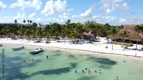 Wild tropical palms island beach. Pristine coral sand palm trees beach and crystal clean turquoise seawater. Mexico, Tulum, Cancun. Drone footage 4K.