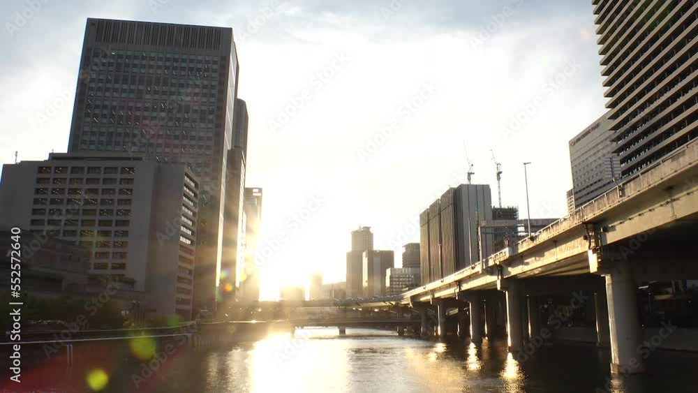 OSAKA, JAPAN - SEP 2022 : View of office buildings near Osaka station, high way and Dojima river in sunset. Time lapse shot, dusk to night. Japanese business, real estate and urban city concept video. OSAKA, JAPAN - SEP 2022 : View of office buildings near Osaka station, high way and Dojima river in sunset. Time lapse shot, dusk to night. Japanese business, real estate and urban city concept video.