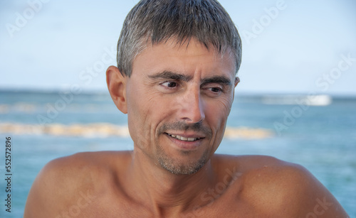 Portrait of a happy caucasian man relaxing on a beautiful beach