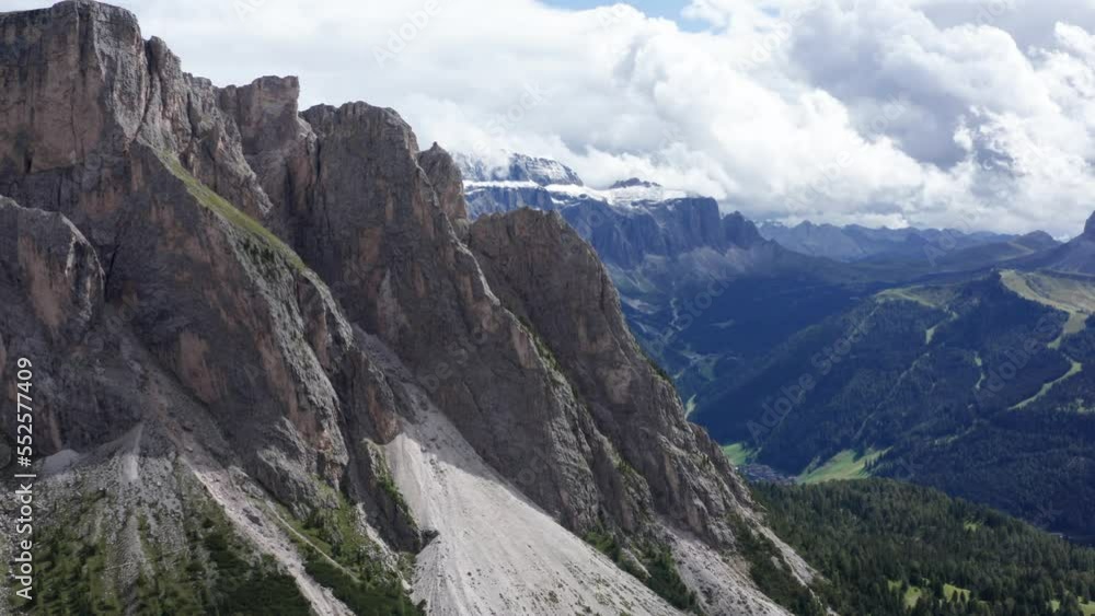 Slow forward flight showing Sella Group Mountains in Puez Odle National Park during cloudy day Slow forward flight showing Sella Group Mountains in Puez Odle National Park during cloudy day