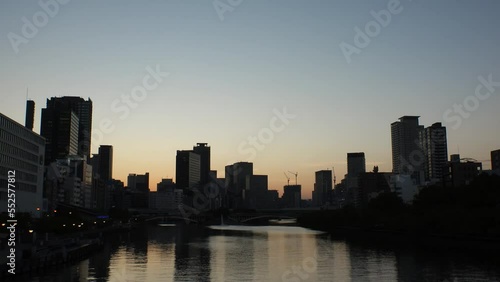 Wallpaper Mural OSAKA, JAPAN - SEP 2022 : Office buildings at Kitahama area and river in sunset. Large business district in Osaka. Time lapse shot, dusk to night. Japanese business, company and urban city concept. Torontodigital.ca