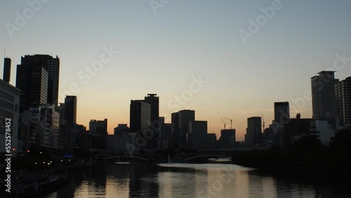 Wallpaper Mural OSAKA, JAPAN - SEP 2022 : Office buildings at Kitahama area and river in sunset. Large business district in Osaka. Time lapse shot, dusk to night. Japanese business, company and urban city concept. Torontodigital.ca