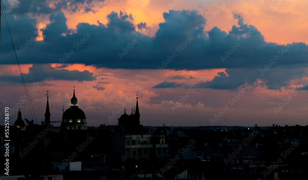 Skyline of Madrid, Spain, at nightfall. Old town district. Cloudy warm sky.