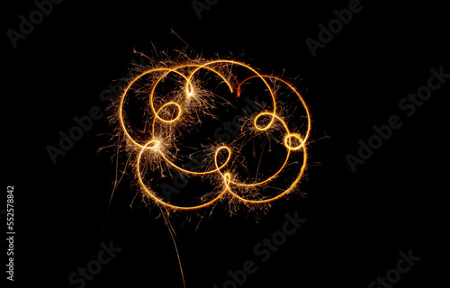 Sparks of a sparkler on a black background. A light moving in the dark.