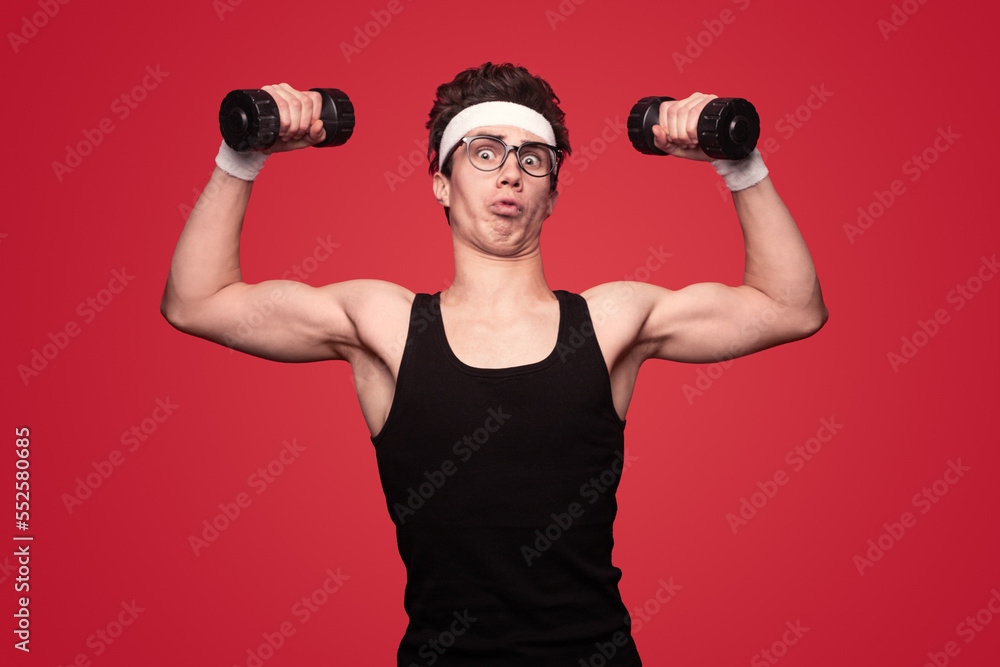 Funny nerd exercising with dumbbells Funny nerd exercising with dumbbells