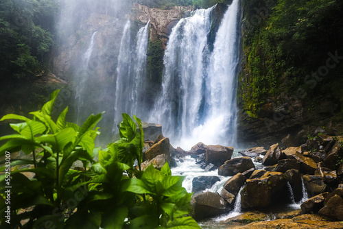 powerful nauyaca waterfall in costa rica at sunrise, large tropical waterfall in costa rica rainforest