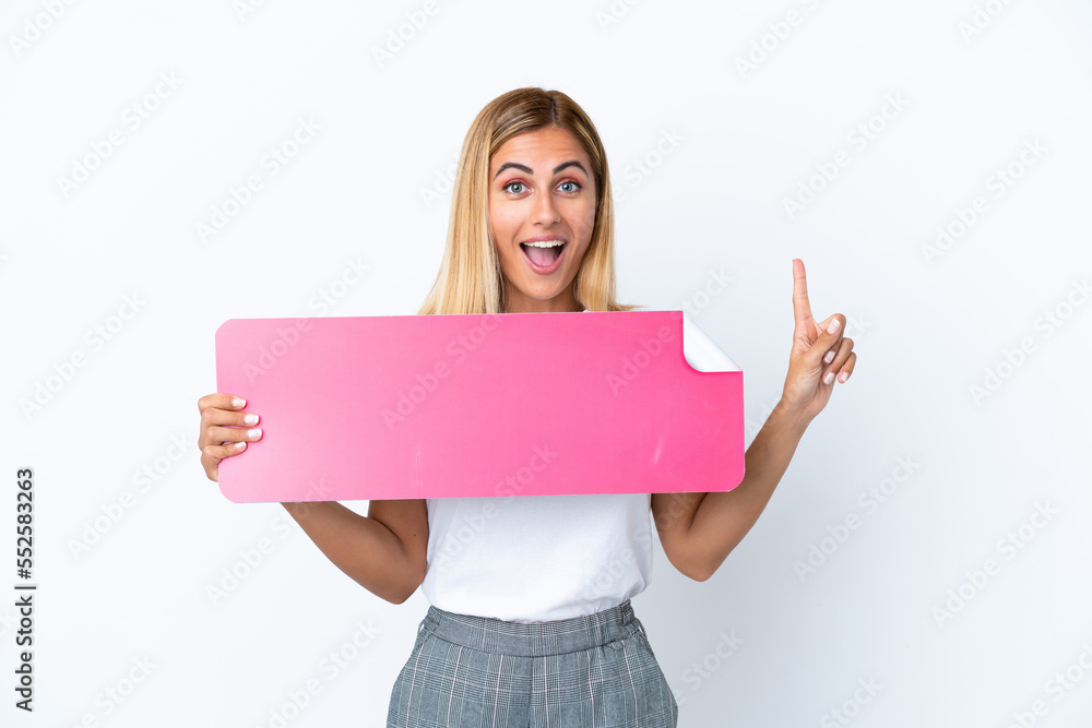 Blonde Uruguayan girl isolated on white background holding an empty placard Blonde Uruguayan girl isolated on white background holding an empty placard