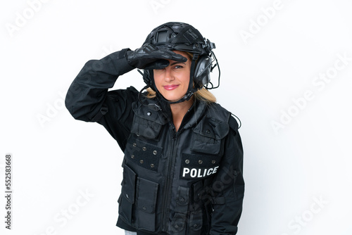 SWAT caucasian woman isolated on white background looking far away with hand to look something © luismolinero
