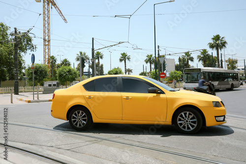 Yellow modern car on road on sunny day