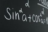 Math formula written on chalkboard, closeup view
