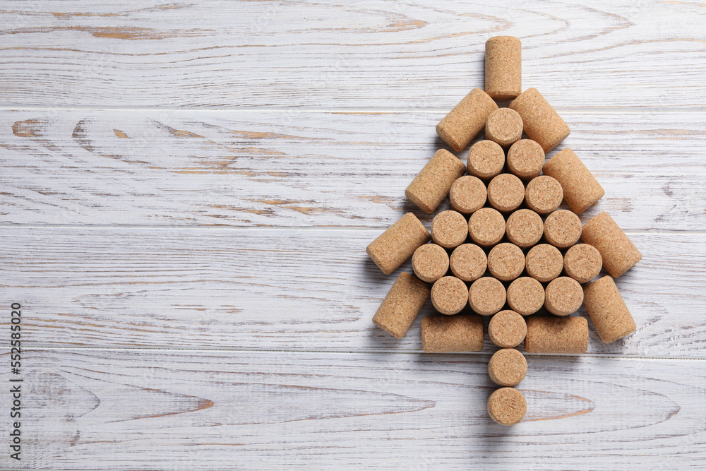 Christmas tree made of wine corks on white wooden table, top view. Space for text Christmas tree made of wine corks on white wooden table, top view. Space for text