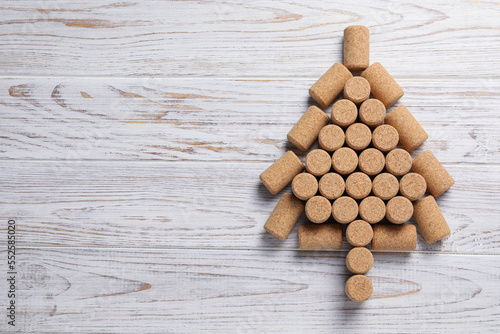 Christmas tree made of wine corks on white wooden table, top view. Space for text