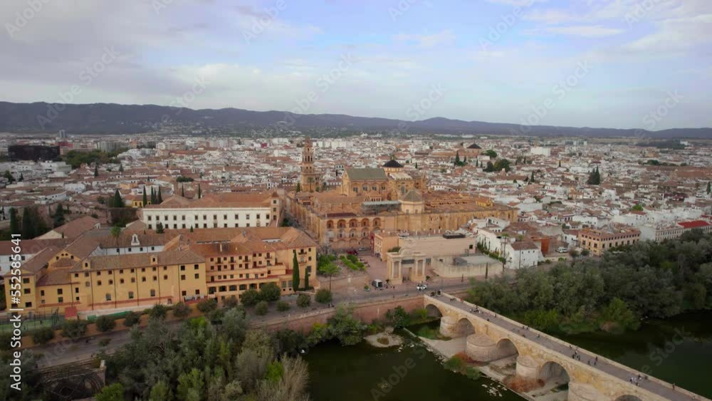 The drone aerial view of the Mosque–Cathedral of Córdoba and Puente Romano bridge. The drone aerial view of the Mosque–Cathedral of Córdoba and Puente Romano bridge.