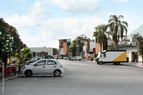 Picturesque view of city street with cars on road near beautiful buildings © New Africa