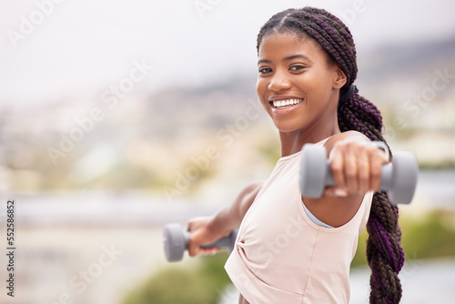 Fototapeta Naklejka Na Ścianę i Meble -  Black woman, smile and dumbbell workout outdoor for fitness training, sports exercise and healthy body lifestyle. Bodybuilder challange, wellness motivation and athlete african woman happy portrait
