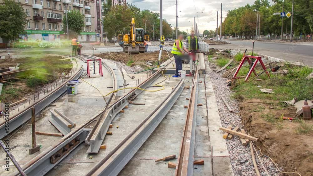 Workers drill holes for mounting and install new tram rails on concrete plates during a reconstruction of the route timelapse. Modernizations of tram tracks