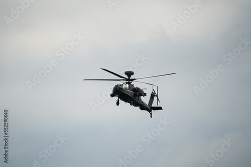 British army AH-64E Boeing Apache Attack helicopter (ZM722 ArmyAir606) on landing approach, autumn sky