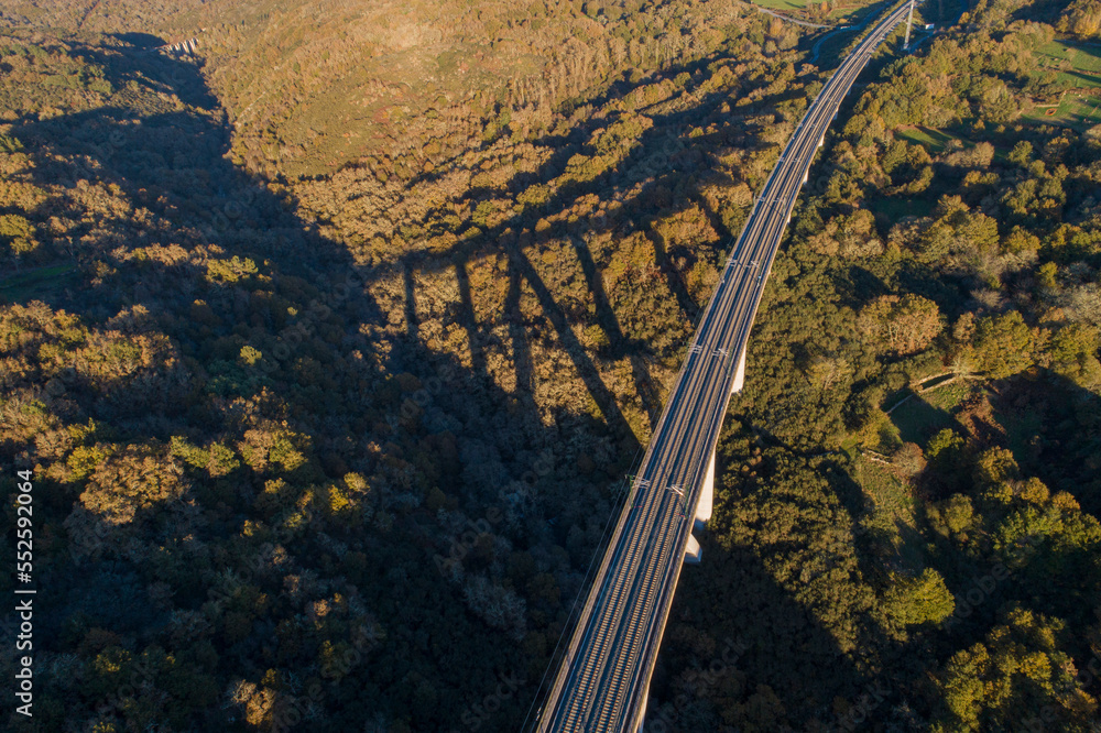 drone aerial view of a high speed railway line on a viaduct at sunset drone aerial view of a high speed railway line on a viaduct at sunset