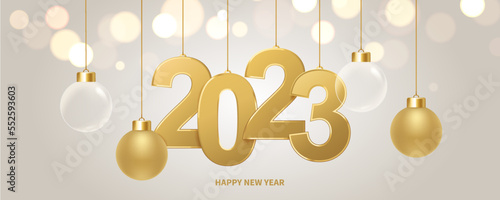 Happy new year 2023 background. Golden numbers and Christmas decoration with shiny lights in background. Holiday greeting card.
